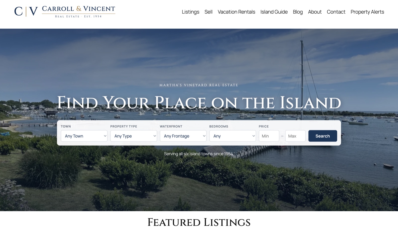 The Carroll & Vincent Real Estate website — a harbor photo with a property search bar.